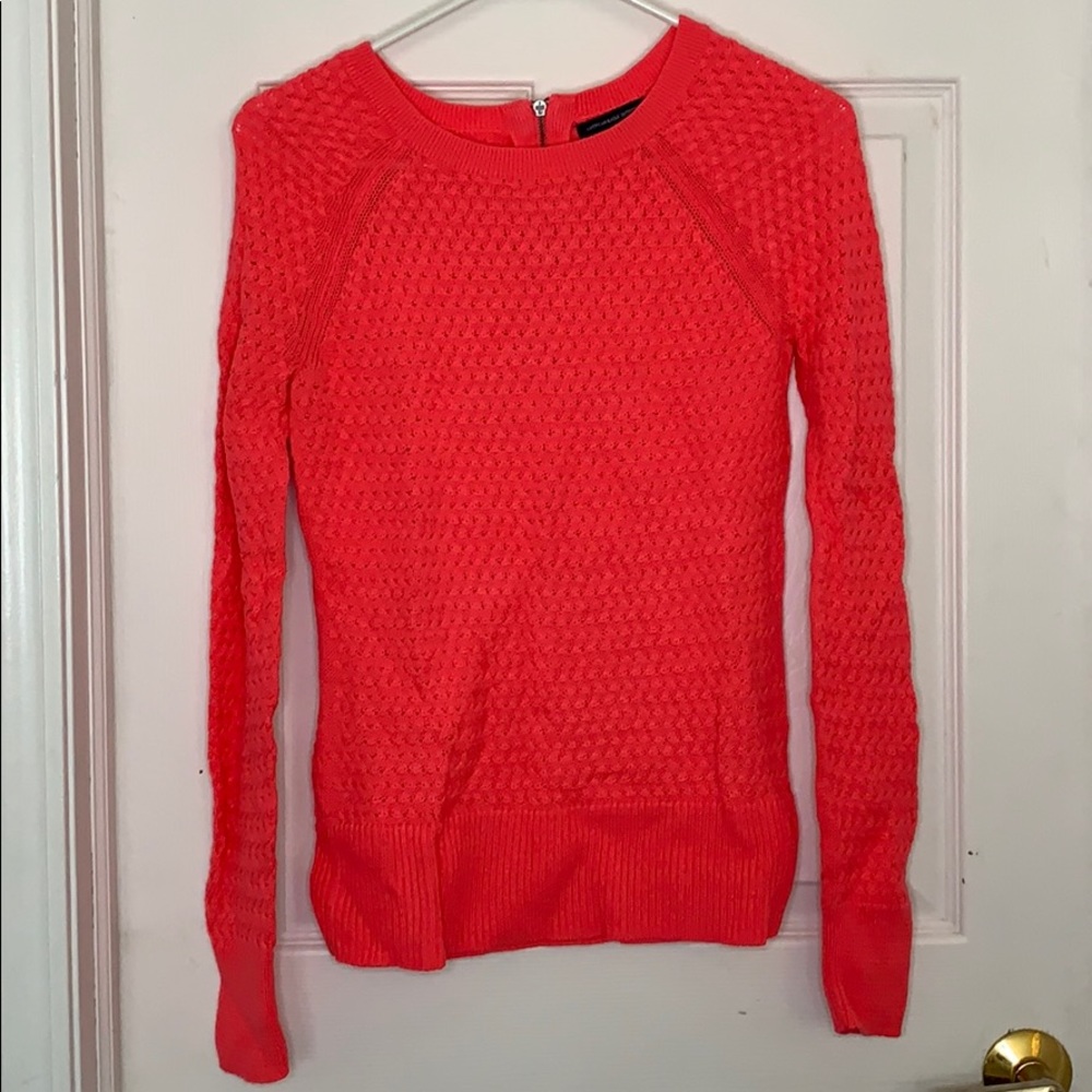 Bright pink sweater with zipper on back